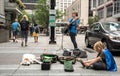 Woman playing guitar for tips.