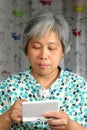 Woman playing handheld game console Royalty Free Stock Photo