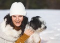 Woman playing with her dog on snow Royalty Free Stock Photo