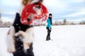 Woman is playing with her dog in the snow at the winter season, frisbee or flying disc Royalty Free Stock Photo