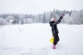 woman playing with her dog on snow in winter. taking pictures by phone selfie Royalty Free Stock Photo