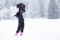 woman playing with her dog on snow in winter. taking pictures by phone selfie Royalty Free Stock Photo