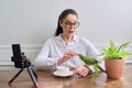 Woman playing with her pet parrot at home, bird biting woman& x27;s finger Royalty Free Stock Photo