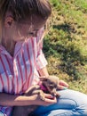 Woman playing pinscher ratter dog outside