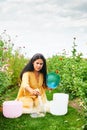 Woman playing music on crystal singing bowls