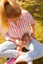 Woman playing pinscher ratter dog outside