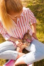 Woman playing pinscher ratter dog outside