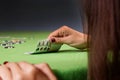 Woman playing poker game and looking at cards. Green table, chips and four aces cards in hand. Royalty Free Stock Photo