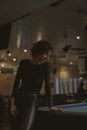 Woman playing pool at a bar Royalty Free Stock Photo