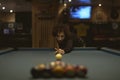 Woman playing pool at a bar Royalty Free Stock Photo
