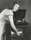 Woman playing record album on phonograph Royalty Free Stock Photo