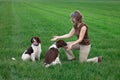 Woman playing with relaxed happy dogs