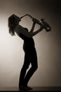 Woman playing saxophone, sepia toned. Royalty Free Stock Photo