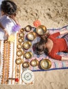 Woman playing a singing bowls also known as Tibetan Singing Bowls, Himalayan bowls. Making sound massage.