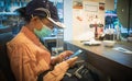 A woman playing with a smartphone while waiting for the food ordered in restaurant Royalty Free Stock Photo