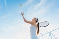 Woman playing tennis giving service Royalty Free Stock Photo