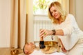 Woman playing on a tibetian singing bowl maling massage meditation for a man Royalty Free Stock Photo