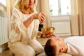 Woman playing on a tibetian singing bowl maling massage meditation for a man Royalty Free Stock Photo