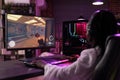 Woman playing video games late at night