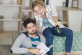 woman playing video games and man reading book Royalty Free Stock Photo