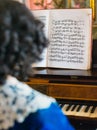 Woman playing vintage piano.