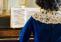 Woman playing vintage piano.