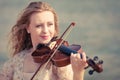 Woman playing violin on violin near beach Royalty Free Stock Photo