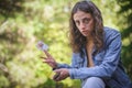 Woman plays cards and holds a joker in her hand Royalty Free Stock Photo