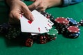 A woman plays in a casino. opening cards to raise bets. Against the background of chips. Poker victory Royalty Free Stock Photo