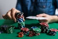 A woman plays in a casino. opening cards to raise bets. Against the background of chips. Poker victory Royalty Free Stock Photo