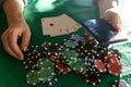 A woman plays in a casino. opening cards to raise bets. Against the background of chips. Poker victory Royalty Free Stock Photo