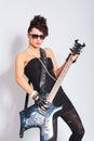 Woman plays an electric guitar Royalty Free Stock Photo