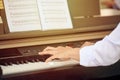 Woman plays electric piano at outdoor music performance, close up view to nimble hands