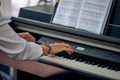 Woman plays electric piano at outdoor music performance, close up view to nimble hands
