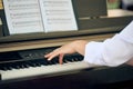 Woman plays electric piano at outdoor music performance, close up view to nimble hands