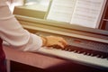 Woman plays electric piano at outdoor music performance, close up view to nimble hands