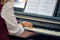 Woman plays electric piano at outdoor music performance, close up view to nimble hands