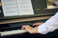 Woman plays electric piano at outdoor music performance, close up view to nimble hands