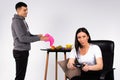 The woman plays a game while her man washes the dishes. White background and gender stereotypes.
