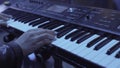 Woman plays by hands on white digital piano, close-up shooting with defocus. Stock. Girl is playing by fingers on Royalty Free Stock Photo