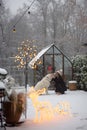 Woman plays with her dog on snowy backyard