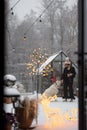 Woman plays with her dog on snowy backyard