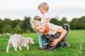 Woman plays with her son and two small dogs Royalty Free Stock Photo