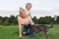 Woman plays with her son and two small dogs Royalty Free Stock Photo
