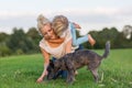 Woman plays with her son and two small dogs Royalty Free Stock Photo