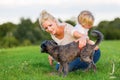 Woman plays with her son and two small dogs Royalty Free Stock Photo