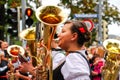 Woman plays a horn during the Brewers` Parade