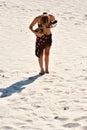 Woman plays mandolin in the sand