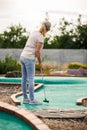 Woman plays miniature golf at course