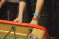 Woman plays table football table soccer in a bar Closeup of the player`s hands Royalty Free Stock Photo